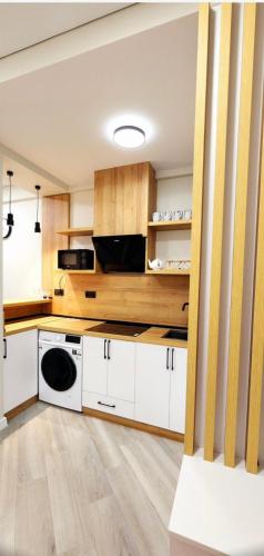 a kitchen with white cabinets and a microwave at Bamboo Beach Tsikhisdziri 347K in Tsikhisdziri