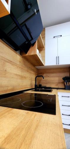 a kitchen with a black sink and wooden counters at Bamboo Beach Tsikhisdziri 347K in Tsikhisdziri