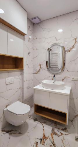 a white bathroom with a toilet and a sink at Bamboo Beach Tsikhisdziri 347K in Tsikhisdziri