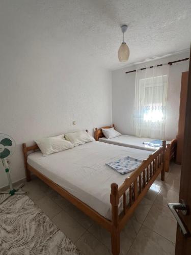 a bedroom with two beds and a window at Haus Binas in Ulcinj