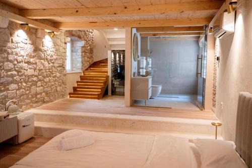 A bed or beds in a room at Lillium Heritage Luxury Suite Diocletian's Palace