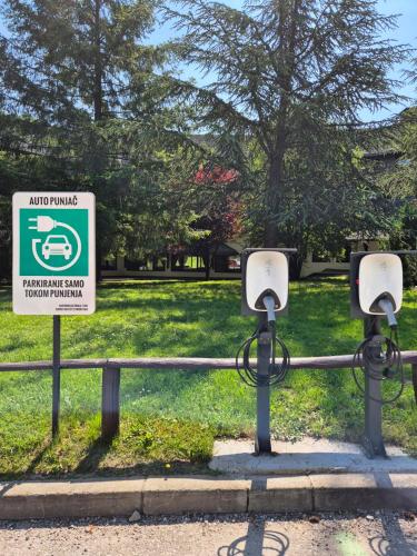 two cameras on a rail with a sign in a park at Hotel Junior in Kopaonik