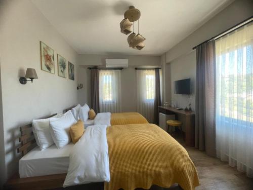 a bedroom with a large bed with a yellow blanket at Kyla Kocadere Mansion in Eceabat