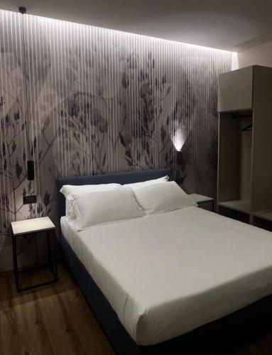 a bedroom with a bed and a wall with flowers at Hotel La Rocca in San Marino
