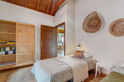 a bedroom with a bed and a chair in it at Complejo Rural Pajar de Bento in Agulo
