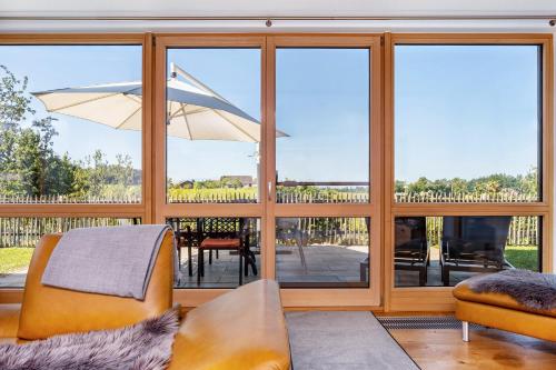 a living room with sliding glass doors and a patio at Ferienwohnung Auf Dem Haldershof in Wangen im Allgäu