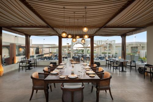 a dining room with a long table and chairs at Pickalbatros Golf Luxury Suites - All Inclusive in Sharm El Sheikh