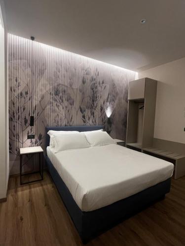 a bedroom with a bed and a wall at Hotel La Rocca in San Marino