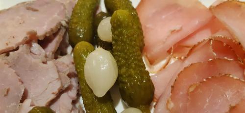 a plate of food with meat and green peas at Villa Marie in Courçon