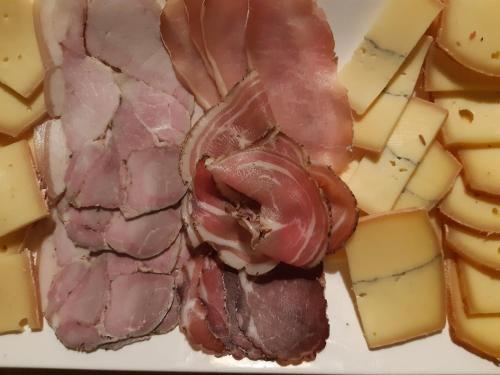 a piece of meat and cheese on a plate at Villa Marie in Courçon