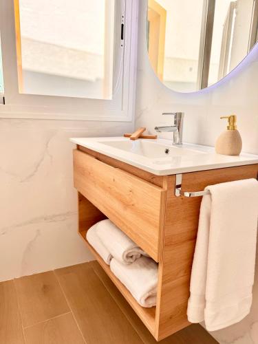 a bathroom with a sink and a mirror at Apartamentos Ana Marbella centro in Marbella