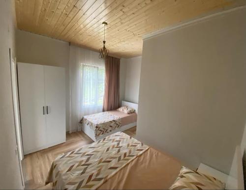 a bedroom with two beds and a window at andiria in Gonio