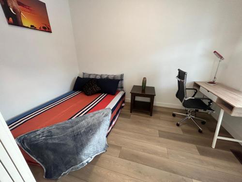 a bedroom with a bed and a desk and a desk at Seton Villas Cozy Four-bed house in Calgary