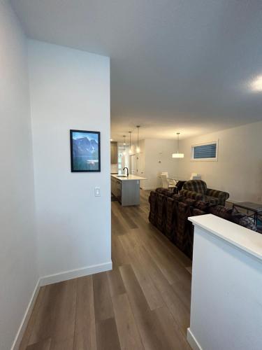 a living room with a couch and a table at Seton Villas Cozy Four-bed house in Calgary
