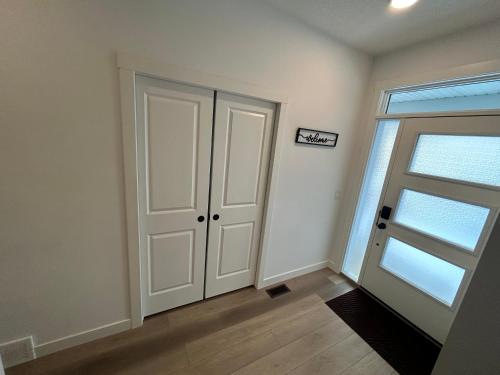 an empty room with a door and a window at Seton Villas Cozy Four-bed house in Calgary