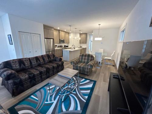 a living room with a couch and a table at Seton Villas Cozy Four-bed house in Calgary