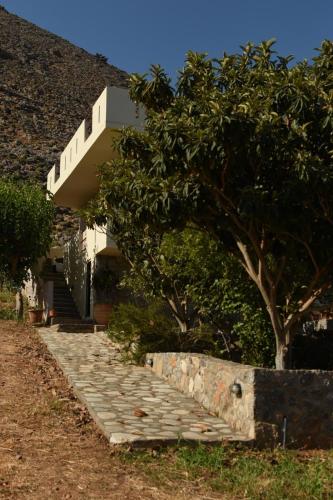a house with a staircase leading up to a building at Artemisa House in Agia Roumeli