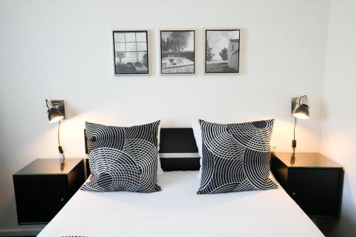 a bedroom with a bed with black and white pillows at Golf Hotel Viborg in Viborg
