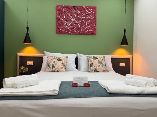a bedroom with a bed with two towels on it at Casa Teresa Guest Rooms in Parghelia