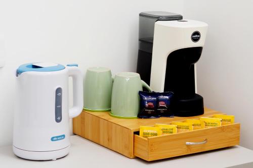 a coffee maker sitting on a wooden tray next to a coffee maker at Casa Teresa Guest Rooms in Parghelia