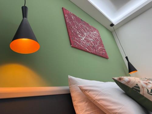 a bedroom with a bed with an orange lamp and avertisement at Casa Teresa Guest Rooms in Parghelia