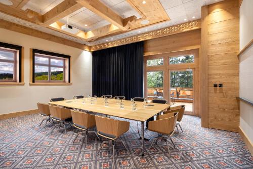 a conference room with a large table and chairs at Hotel Bania Thermal & Ski in Białka Tatrzanska
