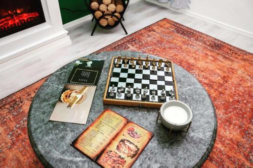 a chessboard and books on a table in a living room at Forest Central Sarajevo in Sarajevo