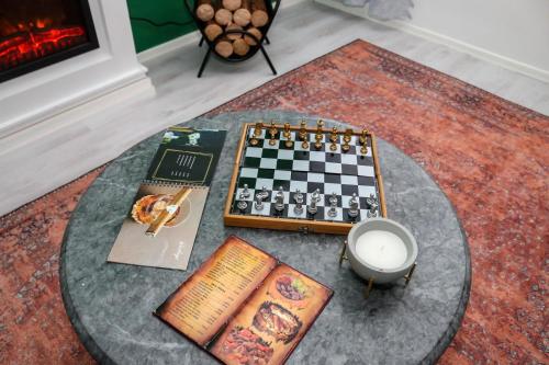 a chessboard and books on a table in a living room at Forest Central Sarajevo in Sarajevo
