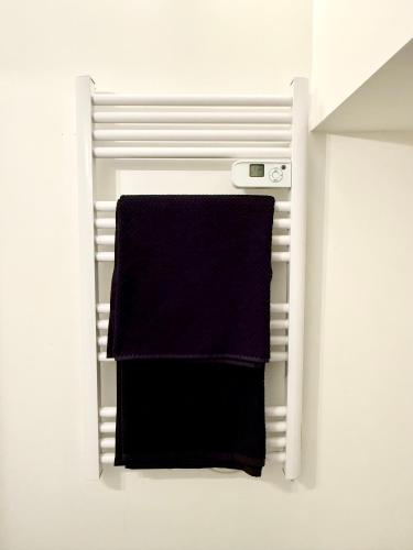 a towel hanging on a towel rack in a bathroom at Provençal Studio - Vieil Antibes in Antibes