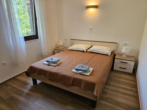 a bedroom with a bed with two towels on it at Villa Kučan in Porat