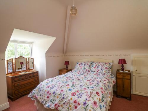 a bedroom with a bed and a dresser and a window at Knockroe Lodge in New Ross