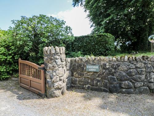 a stone wall with a gate in front of it at Knockroe Lodge in New Ross