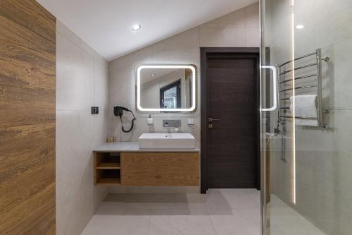 a bathroom with a sink and a mirror at Chalet 348 in Palyanytsya