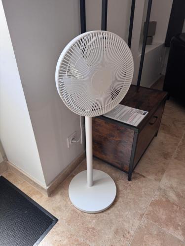 a white fan sitting on the floor next to a table at Escapade à Pommard in Pommard