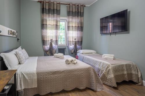 a bedroom with two beds with towels on them at Aurelia Garden Suite in Rome