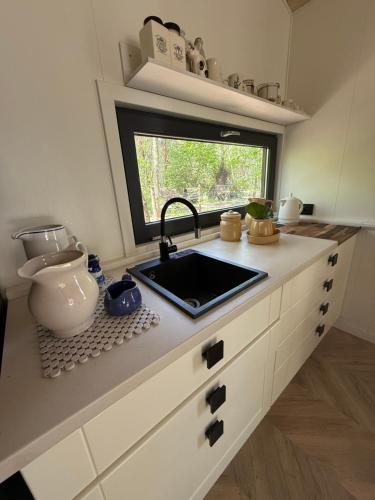 a kitchen with a sink and a window at WieloHome in Wielogóra