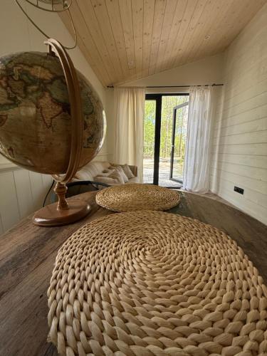 a large wicker bed in a room with a world globe at WieloHome in Wielogóra