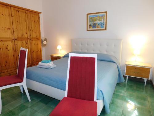a bedroom with a bed and a red chair at Villa Maria Lake View,7 minuti a piedi dal centro, parcheggio privato in Torri del Benaco