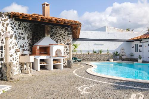 a house with a swimming pool next to a building at Casa do Mar in São Vicente Ferreira