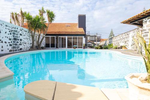 a large blue swimming pool in a building at Casa do Mar in São Vicente Ferreira