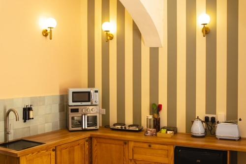 a kitchen with a counter with a microwave on top of it at Mqabba Studio Flat by Talbot & Bons in Mqabba