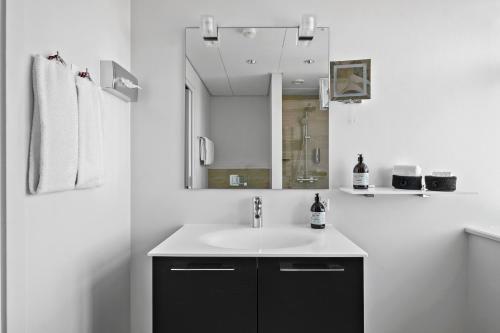 a white bathroom with a sink and a mirror at Best Western Plus Hotel Eyde in Herning