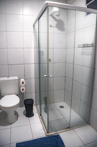 a shower stall in a bathroom with a toilet at Hospedagem Junco Noronha in Fernando de Noronha