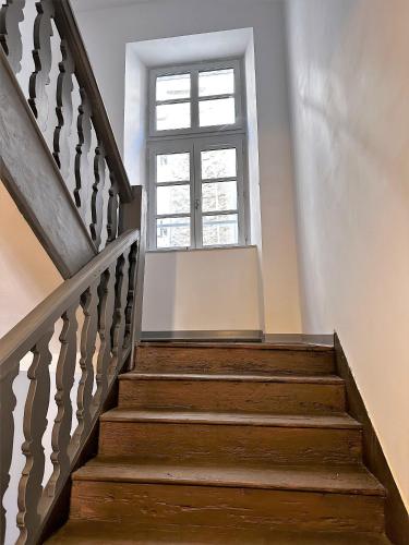 a stairway with a window and a window at 3 pièces silencieux plein centre parking clim patio in Foix