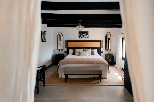 a bedroom with a bed and a black and white ceiling at Hotel Son Molí Country House in Playa de Palma