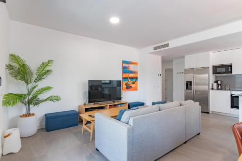a living room with a couch and a table at Beachfront Apartment 034 in Torre del Mar