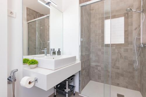 a bathroom with a sink and a shower at Beachfront Apartment 034 in Torre del Mar
