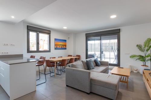 a living room with a couch and a table at Beachfront Apartment 034 in Torre del Mar