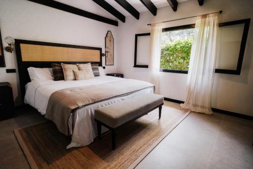 a bedroom with a large bed and a window at Hotel Son Molí Country House in Playa de Palma