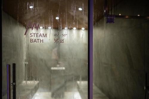 a glass window with the words steam bath on it at Hotel Anewandter in Brunico